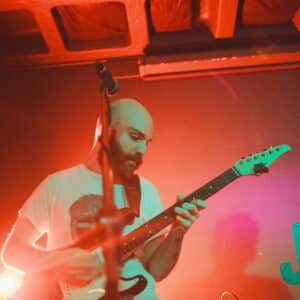 Man on stage playing electric guitar